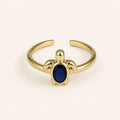 Anillo Tortuga: banda ajustable dorada con motivo de tortuga.