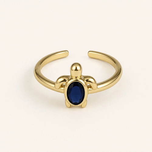 Anillo Tortuga: banda ajustable dorada con motivo de tortuga.
