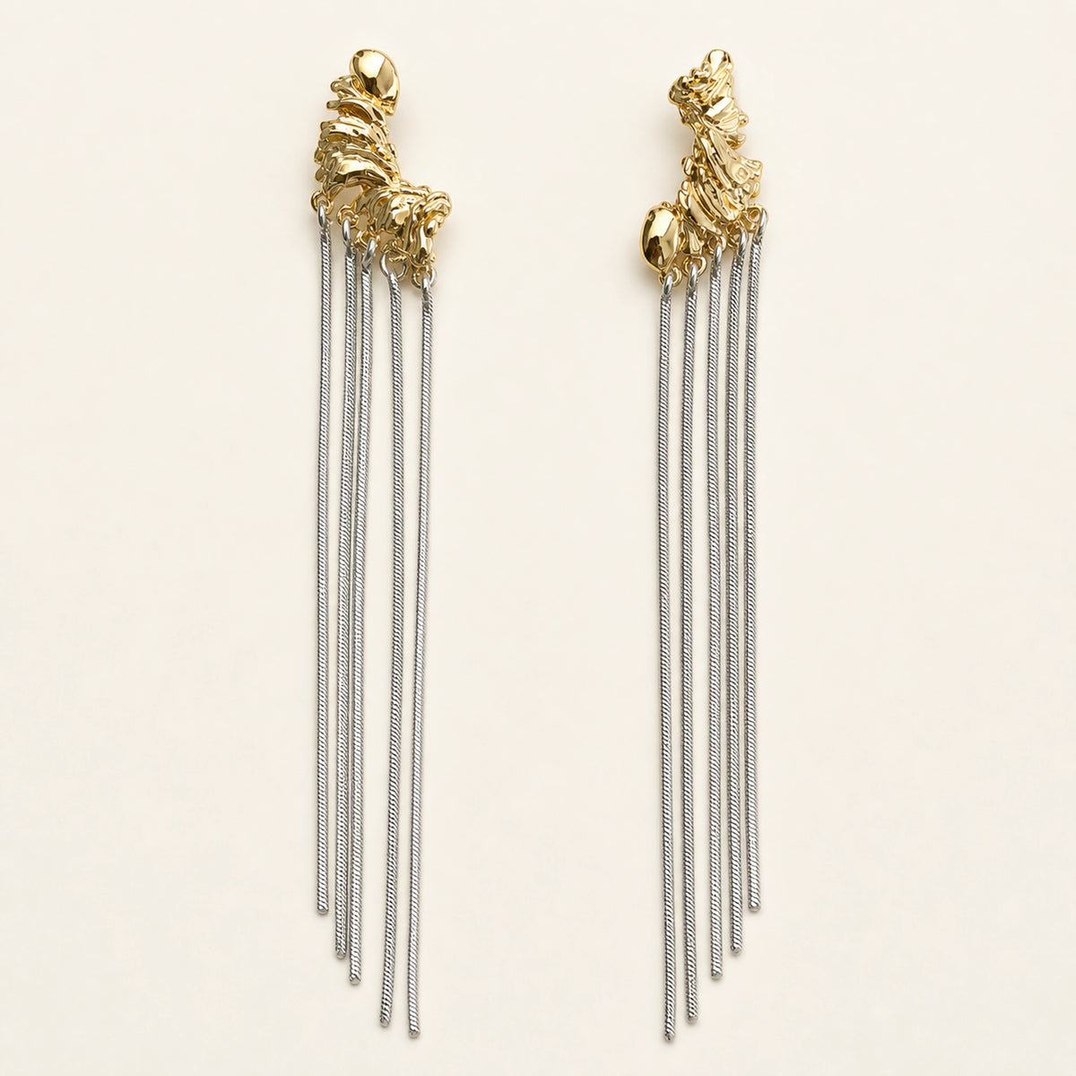 Aretes Cascada: cuerpo dorado con seis tiras plateadas colgantes.